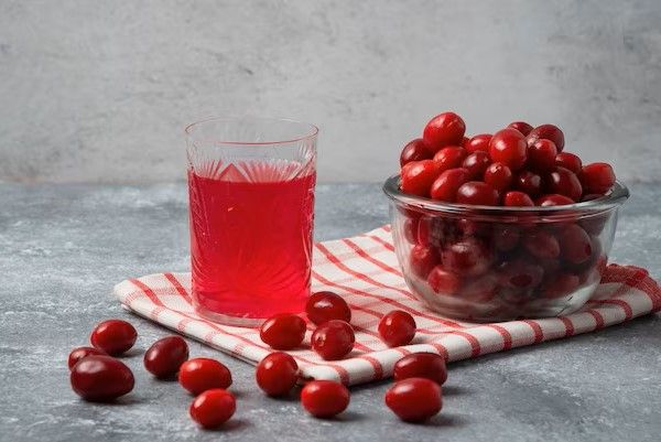 red-cornels-in-the-glass-cup-on-checked-towel-with-a-glass-of-juice_114579-19527.jpg